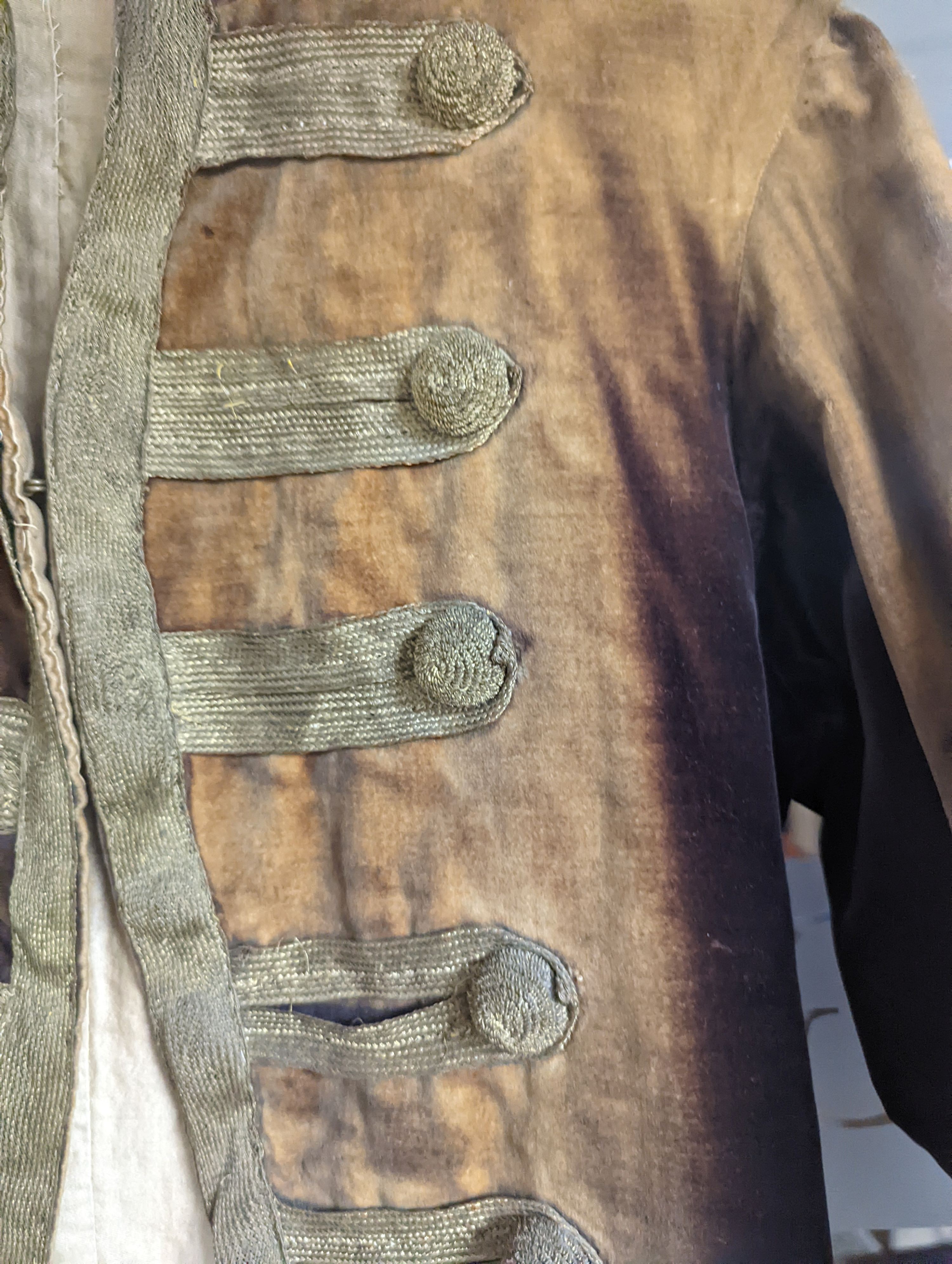 A Georgian gents cream damask waistcoat, a similar waistcoat with beading applied later and a velvet and gold braided tailcoat